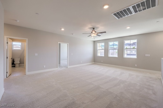 empty room featuring ceiling fan and light colored carpet