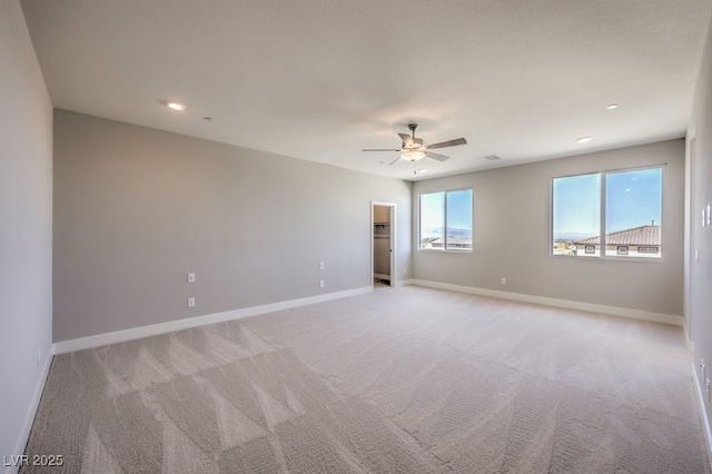 unfurnished room featuring light carpet and ceiling fan