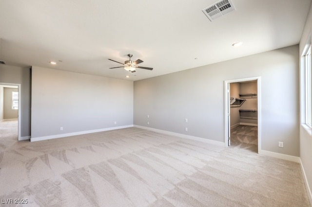 spare room featuring ceiling fan and light carpet