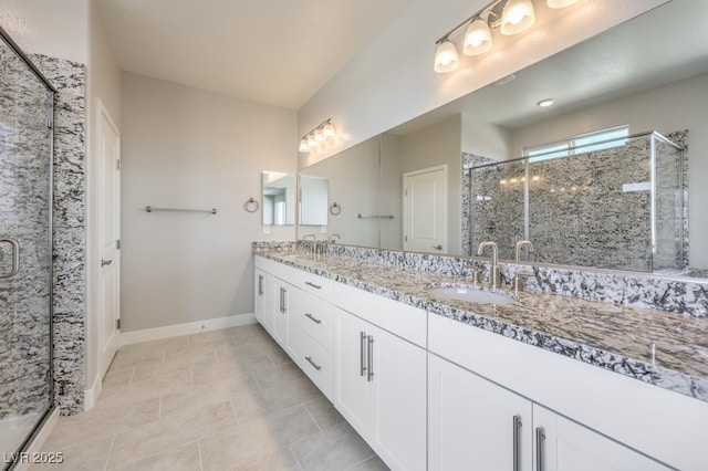 bathroom featuring a shower with shower door and vanity