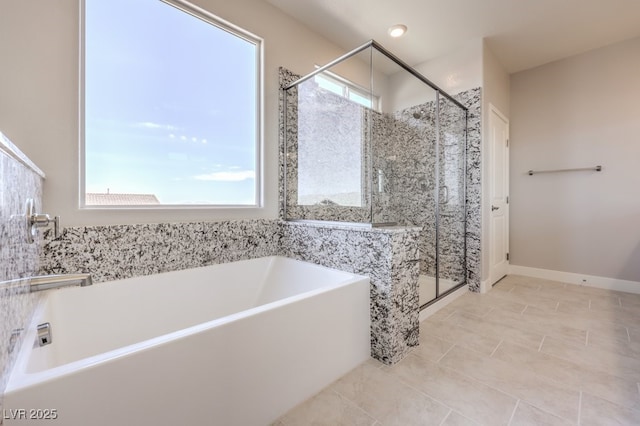 bathroom with shower with separate bathtub and tile patterned floors