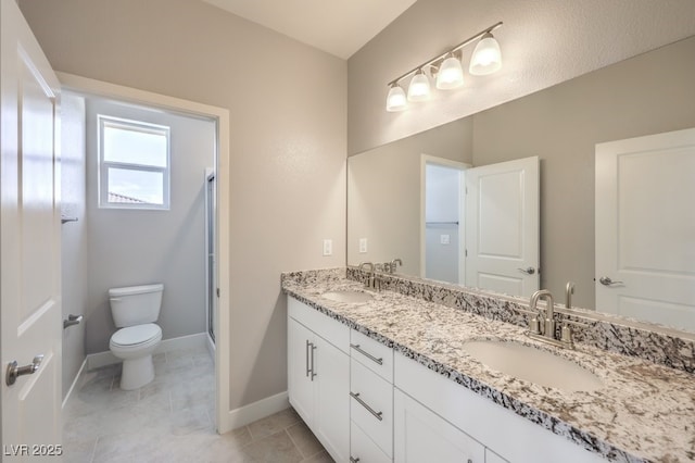 bathroom featuring toilet, tile patterned flooring, a shower with door, and vanity