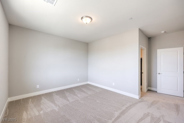 unfurnished room featuring light colored carpet