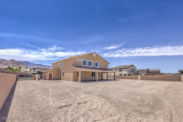 rear view of house with a mountain view