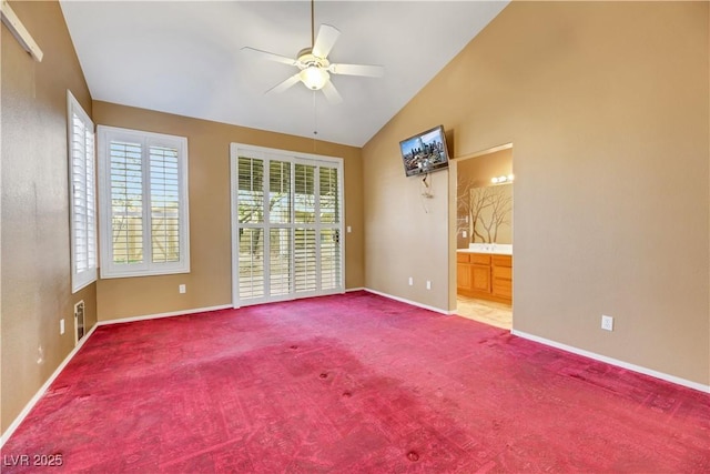 unfurnished room with ceiling fan, lofted ceiling, and carpet floors