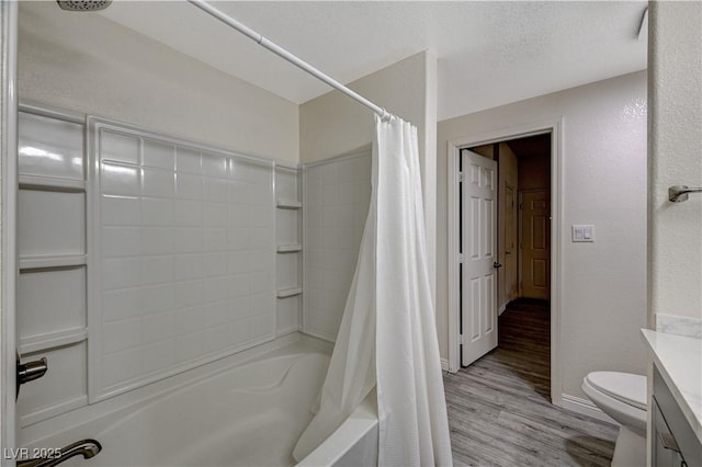 full bathroom with hardwood / wood-style flooring, shower / tub combo, vanity, a textured ceiling, and toilet