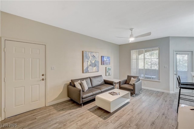 living room featuring ceiling fan and light hardwood / wood-style flooring