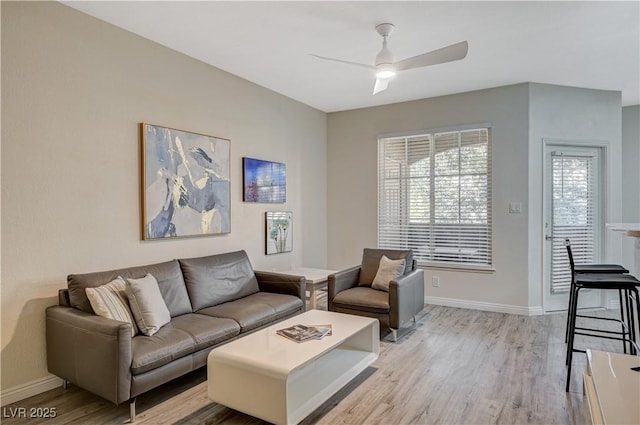 living room with ceiling fan and light wood-type flooring