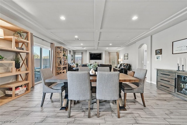 dining room with beam ceiling and coffered ceiling