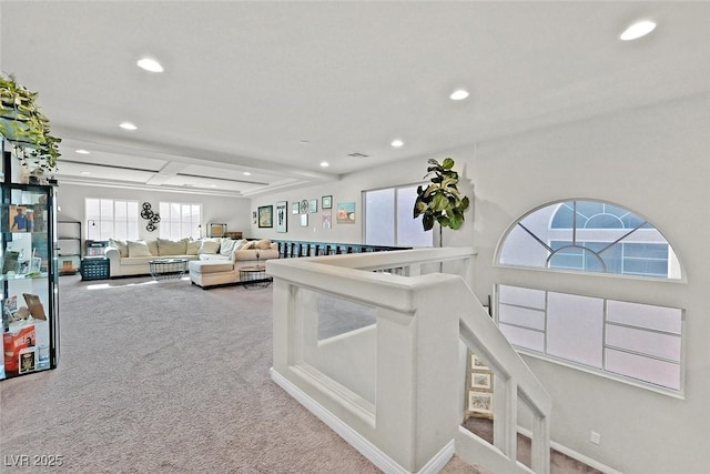 carpeted living room featuring beam ceiling