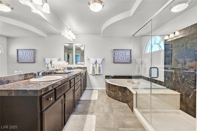 bathroom with tile patterned floors, vanity, and separate shower and tub