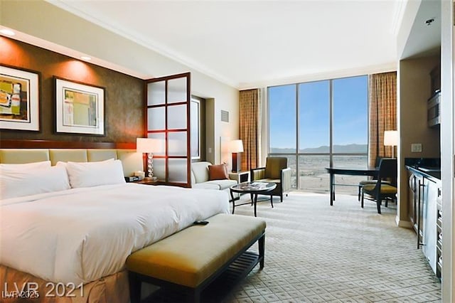 carpeted bedroom featuring a wall of windows, crown molding, and a water view