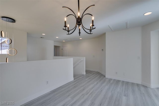 interior space featuring light hardwood / wood-style floors and an inviting chandelier