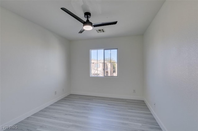 empty room with ceiling fan and light hardwood / wood-style flooring