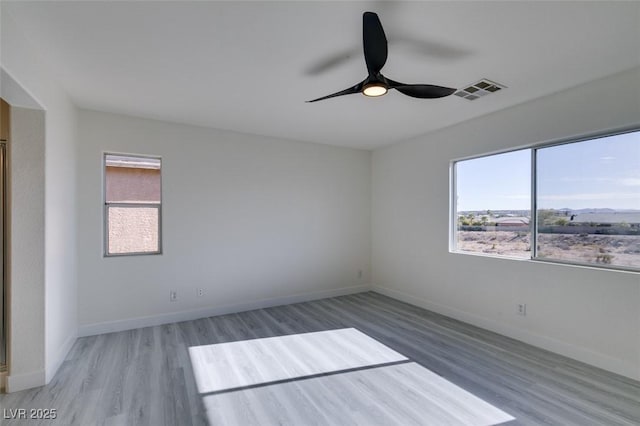 unfurnished room featuring ceiling fan and wood-type flooring