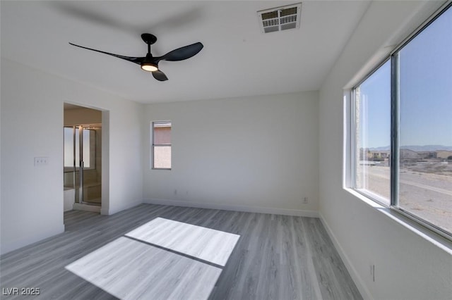 empty room featuring ceiling fan and hardwood / wood-style floors