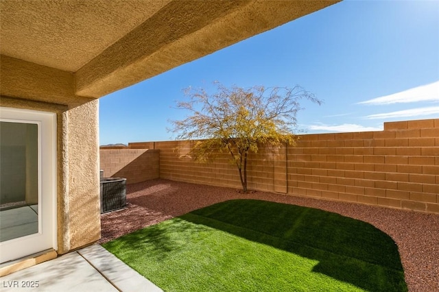 view of yard with cooling unit and a patio