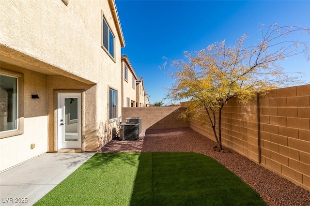 view of yard with a patio area and central AC