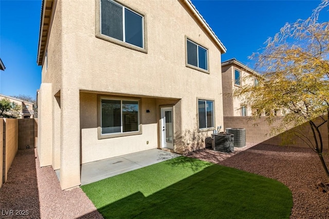 rear view of property featuring cooling unit and a patio area