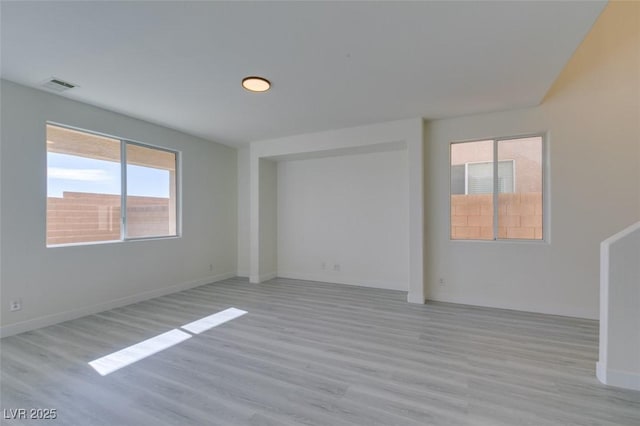 empty room with light hardwood / wood-style flooring