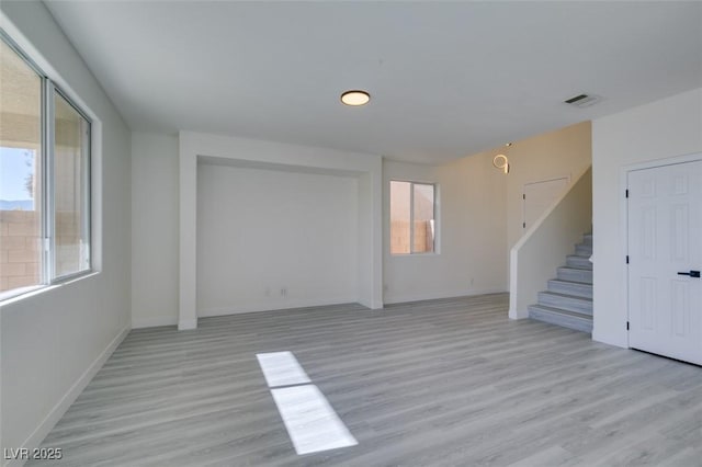 unfurnished room with light wood-type flooring