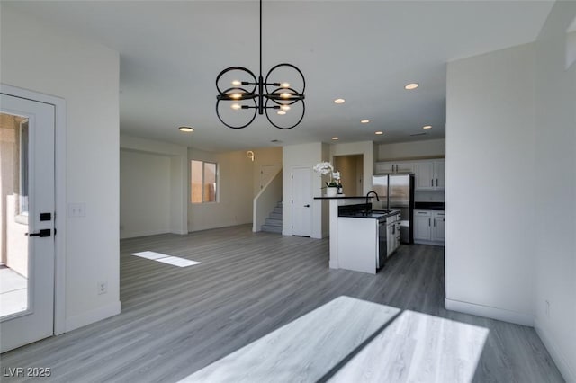 kitchen featuring hanging light fixtures, white cabinets, dark hardwood / wood-style floors, and a chandelier