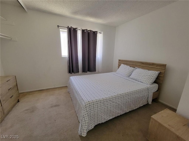 carpeted bedroom featuring a textured ceiling