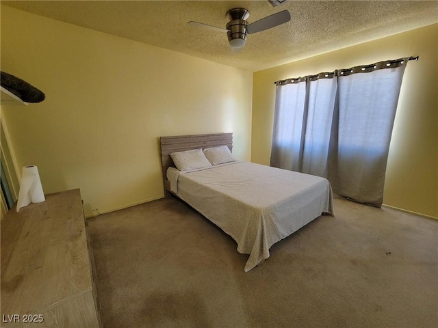 bedroom featuring ceiling fan, a textured ceiling, and carpet flooring