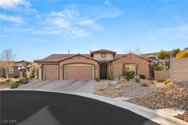 mediterranean / spanish-style home with a garage