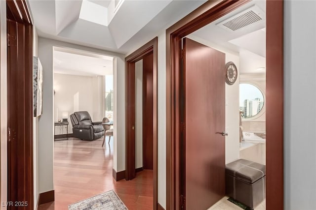 corridor with light hardwood / wood-style flooring