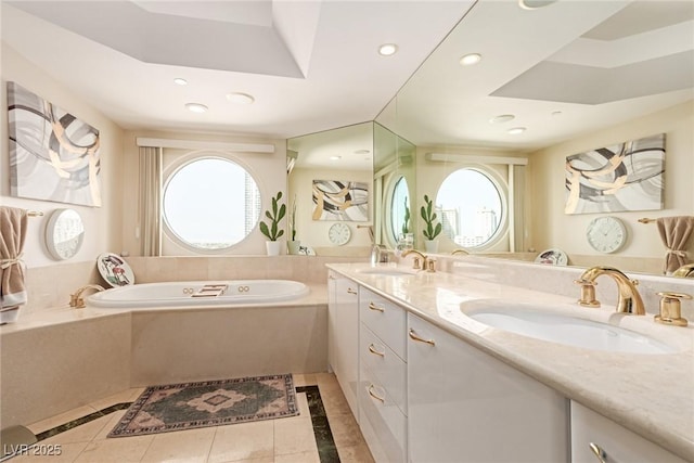 bathroom featuring vanity, tile patterned floors, and tiled bath