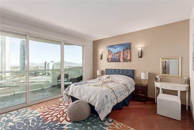 bedroom featuring dark wood-type flooring and access to outside