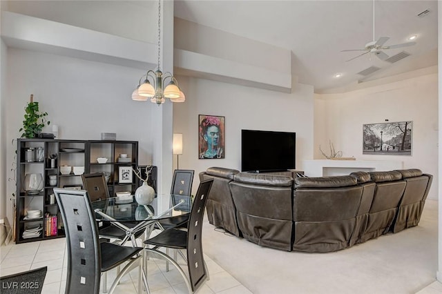 tiled dining area with ceiling fan with notable chandelier