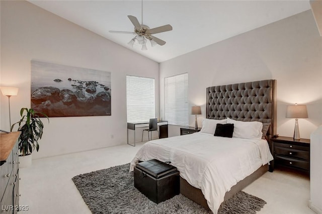 bedroom with ceiling fan, light colored carpet, and vaulted ceiling