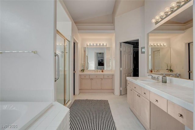 bathroom featuring vanity, separate shower and tub, and lofted ceiling