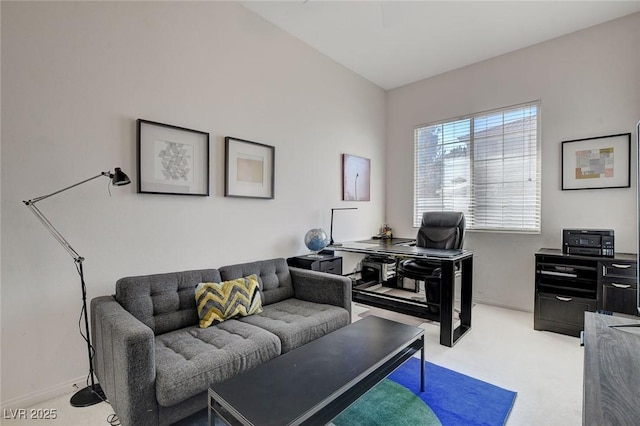 office area with light colored carpet and lofted ceiling