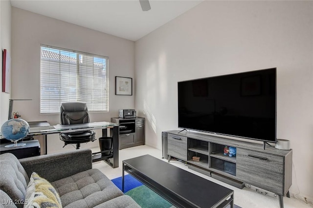 carpeted home office featuring ceiling fan