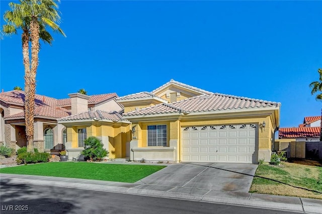 mediterranean / spanish house featuring stucco siding, concrete driveway, a garage, a tiled roof, and a front lawn