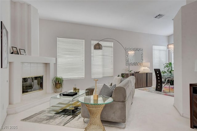 carpeted living room featuring a fireplace