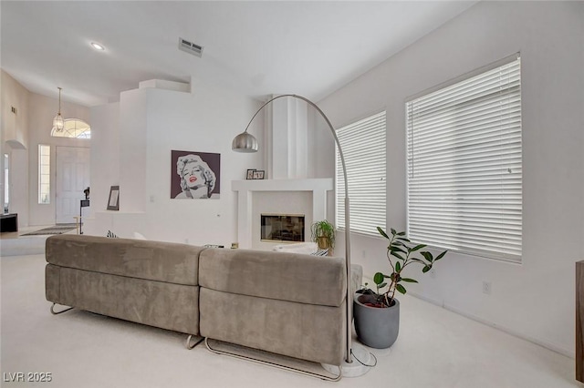 carpeted living room with vaulted ceiling