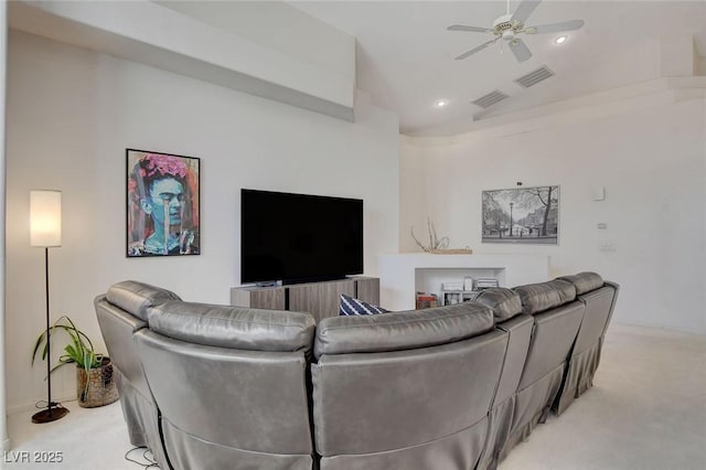 carpeted living room with ceiling fan and lofted ceiling