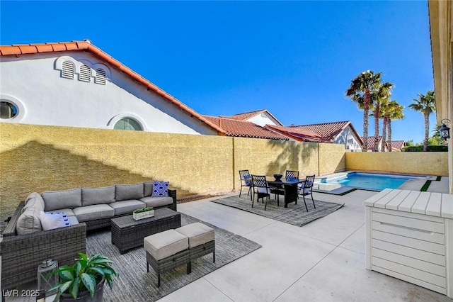 view of patio with a fenced in pool and outdoor lounge area