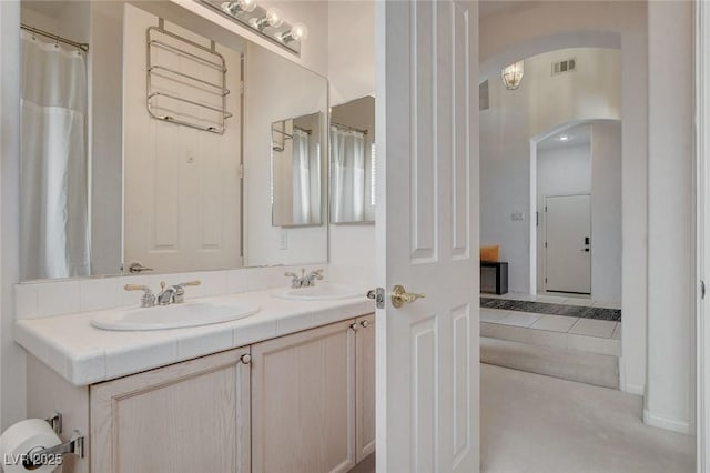 bathroom with tile patterned flooring and vanity