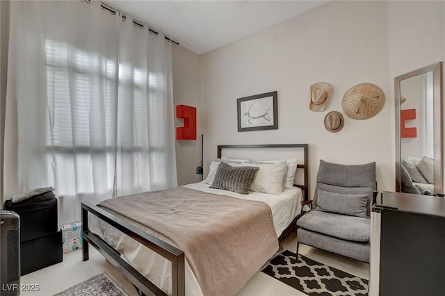 carpeted bedroom featuring multiple windows