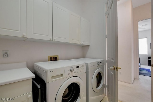 laundry room featuring cabinets and washer and clothes dryer