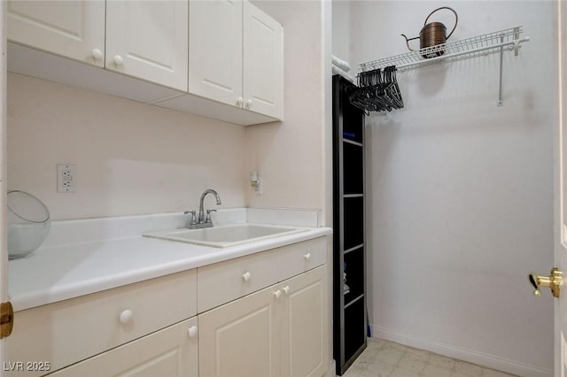 clothes washing area featuring sink