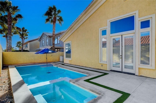 view of pool featuring an in ground hot tub and a patio