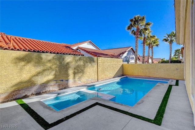 view of pool with an in ground hot tub