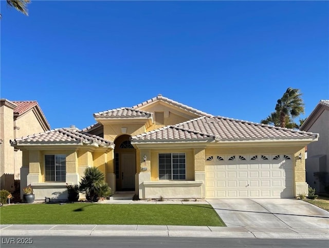 mediterranean / spanish-style house with a garage, driveway, a front yard, and stucco siding