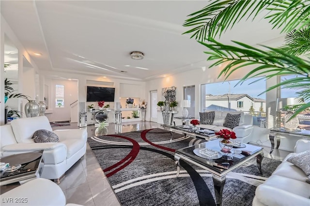 living room featuring a healthy amount of sunlight and tile patterned flooring